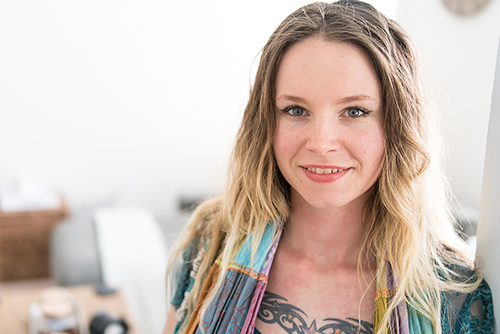 Portait of a young woman with tattoos in a white apartment